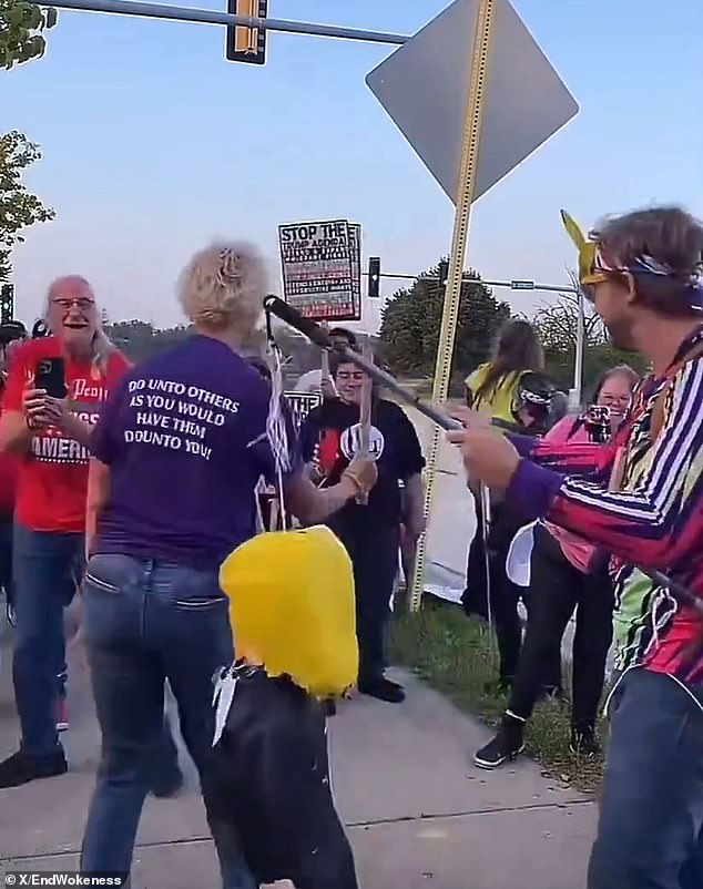 Woman in Golden Rule Shirt Smashes Trump Piñata With Pipe