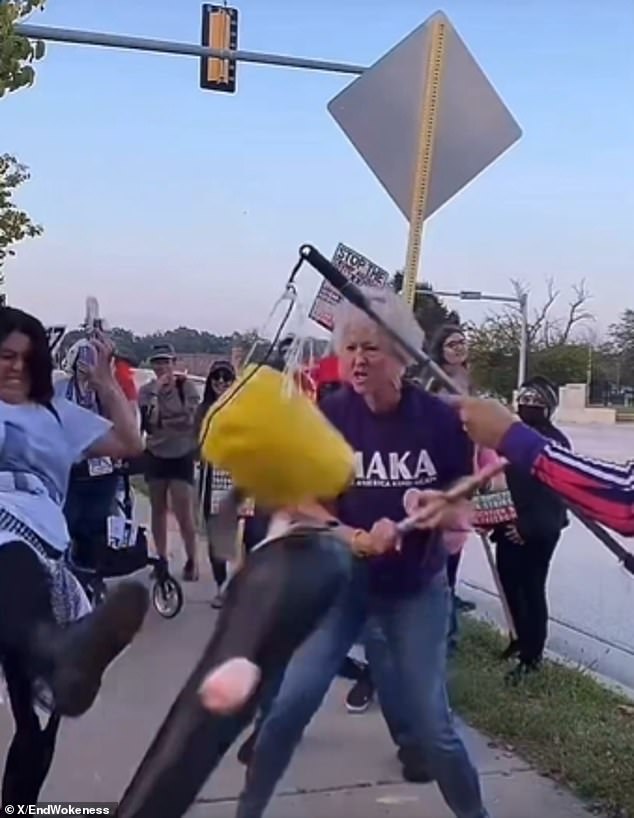 Woman in Golden Rule Shirt Smashes Trump Piñata With Pipe